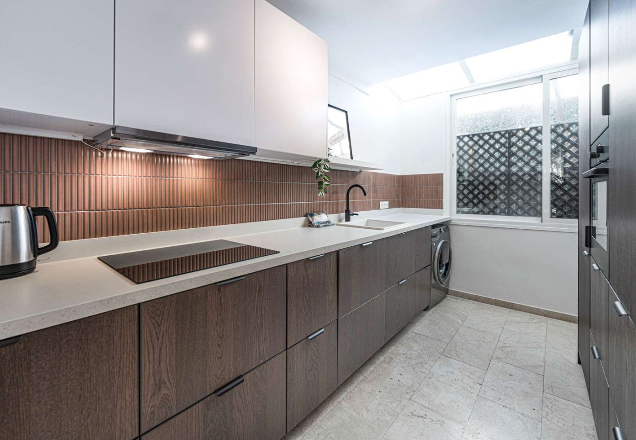 Cucina moderna completamente attrezzata con forno, microonde e design elegante in un alloggio per le vacanze.